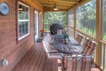 Screened in porch with charcoal and gas grill 